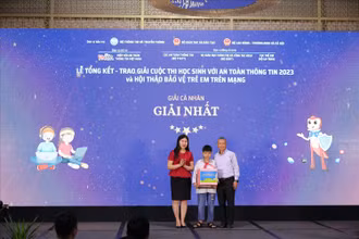 Chủ tịch VNISA Nguyễn Thành Hưng và Phó Cục trưởng Cục Trẻ em Nguyễn Thị Nga trao giải Nhất cho các em học sinh có thành tích xuất sắc. (Nguồn: Báo Dân tộc)