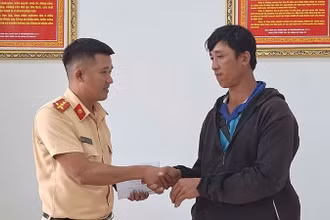Đại úy Kiều Thanh Hùng, cán bộ Đội Cảnh sát giao thông đường bộ số 2, Phòng Cảnh sát giao thông, Công an tỉnh Đắk Lắk bàn giao số tiền 29 triệu đồng cho anh Phan Ngọc Hùng. (Ảnh: CTV)