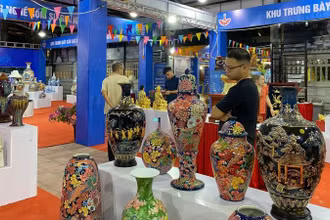 Khách tham quan tìm hiểu về sản phẩm gốm sứ.