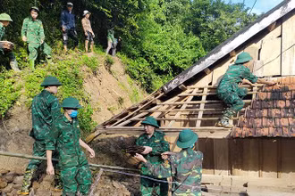 Bộ đội Biên phòng giúp người dân di dời các ngôi nhà có nguy cơ bị sạt lở đất.