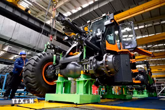 Công nhân làm việc trên dây chuyền sản xuất máy kéo Develon ở Yên Đài, tỉnh Sơn Đông (Trung Quốc) ngày 17/1/2024. (Ảnh: THX/TTXVN)