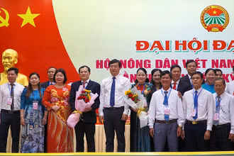 Lãnh đạo Trung ương Hội Nông dân Việt Nam và tỉnh Đồng Tháp tặng hoa chúc mừng đại hội. (Ảnh: HỮU NGHĨA)