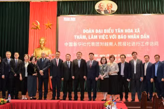 Báo Nhân Dân và Tân Hoa Xã tăng cường giao lưu, hợp tác