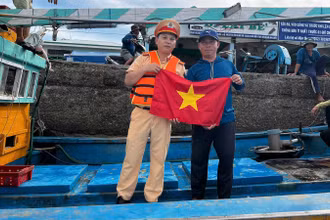 Cảnh sát trao tặng lá cờ cho ngư dân.