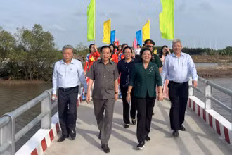 Đại biểu tham dự lễ cùng người dân địa phương vui mừng đi qua cầu Rạch Bà 1 vừa khánh thành, đưa vào sử dụng.