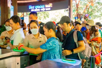 Rất đông du khách xếp hàng mua vé vào tham quan, vui chơi tại Khu du lịch suối khoáng nóng Núi Thần Tài từ sáng sớm. 