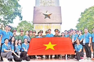 Các đại biểu cùng cán bộ, chiến sĩ tại cột mốc chủ quyền đảo Thổ Châu, một công trình do Trung ương Ðoàn, Trung ương Hội Sinh viên Việt Nam xây dựng. 