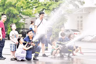 Các em học sinh tham gia thực hành cùng cán bộ, chiến sĩ Trường đại học Phòng cháy chữa cháy. (Ảnh MỸ HÀ) 