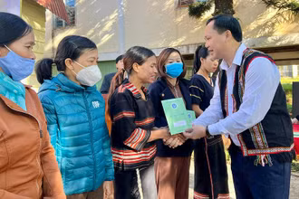 Đại diện Bảo hiểm xã hội Việt Nam trao tặng sổ bảo hiểm xã hội, thẻ bảo hiểm y tế cho người dân có hoàn cảnh khó khăn của làng Ia Nueng, xã Biển Hồ, thành phố Pleiku. (Ảnh: Bảo hiểm xã hội Gia Lai)