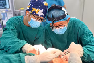 Các bác sĩ đang thực hiện ca phẫu thuật tạo hình vết thương phần mềm má.