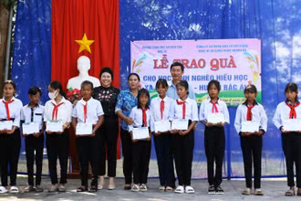 Đại diện nhà tài trợ và lãnh đạo huyện Bác Ái trao quà cho học sinh dân tộc thiểu số Raglai vượt khó học giỏi.