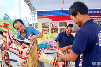 Các nghệ nhân huyện Trà Bồng, tỉnh Quảng Ngãi trang trí, tạo hình cây nêu của người Co. (Ảnh: ĐÔNG HUYỀN)