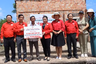 Trao biểu trưng hỗ trợ xây nhà Chữ thập đỏ cho ngư dân nghèo ở xã Đức Minh, huyện Mộ Đức. 