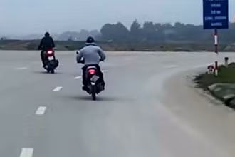 Đối tượng cướp (áo màu ghi) tẩu thoát bằng xe máy. (Ảnh cắt từ video clip)