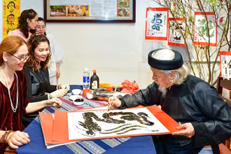 Nhà thư pháp Lê Thiên Lý cho chữ.