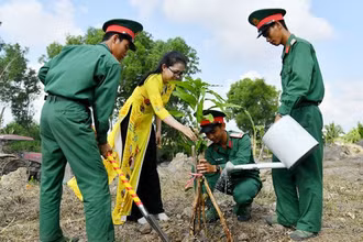 Cán bộ, chiến sĩ Trung đoàn Bộ binh 893 và thanh niên, phụ nữ trên địa bàn đơn vị đóng quân cùng tham gia trồng cây xanh. 