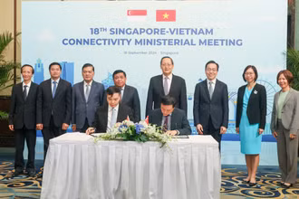 Bộ trưởng Kế hoạch và Đầu tư Nguyễn Chí Dũng và Bộ trưởng Thứ hai Bộ Công nghiệp và Thương mại kiêm Bộ trưởng Nhân lực Singapore, ông Tan See Leng chứng kiến lễ ký kết biên bản ghi nhớ hợp tác giữa các cơ quan của hai bên. (Ảnh: MPI)