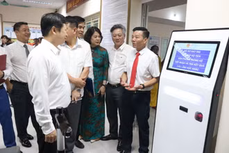 Các đại biểu tham quan mô hình tra cứu thông tin thủ tục và nhận số xếp hàng bằng máy tự động tại phường Mỹ Đình 1.