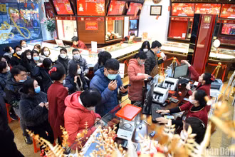 Khách hàng chờ đợi tới lượt mua vàng trong ngày vía Thần Tài tại Công ty TNHH Vàng bạc đá quý Bảo Tín Minh Châu. (Ảnh: Thành Đạt)