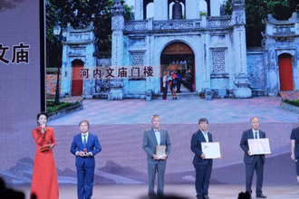 Ông Nguyễn Văn Tú, Phó Giám đốc Trung tâm hoạt động văn hóa khoa học Văn Miếu-Quốc Tử Giám (thứ hai bên trái) giới thiệu mô hình Văn Miếu-Quốc Tử Giám, Hà Nội.