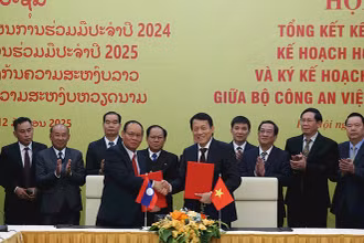 Đồng chí Lương Tam Quang, Ủy viên Bộ Chính trị, Bộ trưởng Công an Việt Nam và đồng chí Vilay Lakhamphong, Ủy viên Bộ Chính trị, Phó Thủ tướng, Bộ trưởng Công an Lào ký hợp tác giữa Bộ Công an hai nước. (Ảnh KHỔNG HÀ)