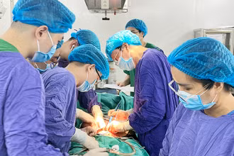 Các bác sĩ Bệnh viện Ung bướu Hà Nội phẫu thuật cho bệnh nhân ung thư. (Ảnh HOÀNG HƯƠNG)