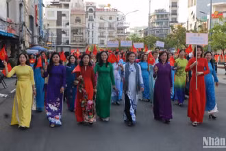 Các đại biểu diễu hành áo dài trên đường phố.