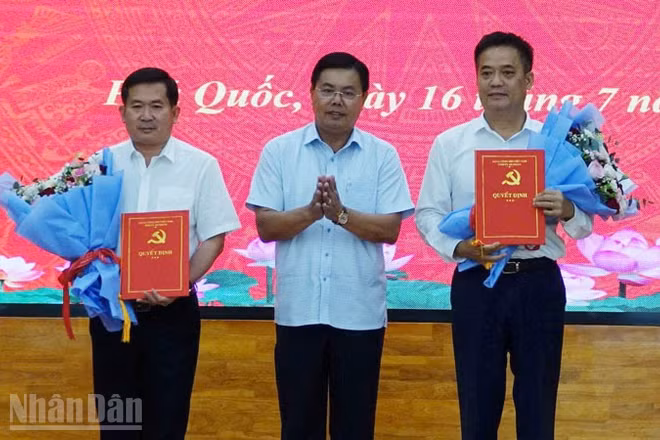 Ủy viên Trung ương Đảng, Bí thư Tỉnh ủy An Giang Nguyễn Tiến Hải trao quyết định và tặng hoa chúc mừng đồng chí Đinh Văn Nơi và đồng chí Lê Quốc Anh. 