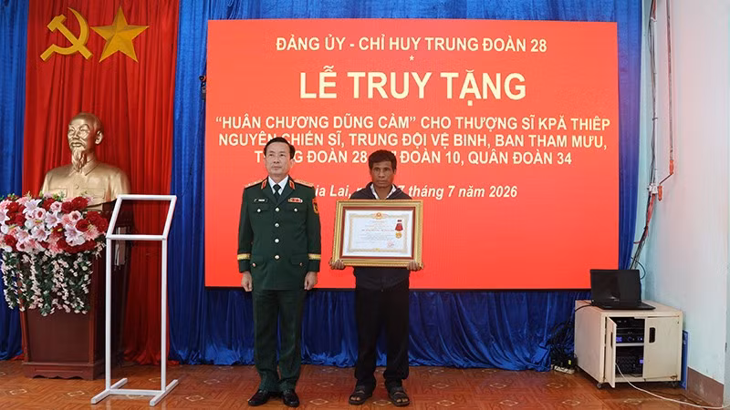 Thừa ủy quyền của Chủ tịch nước, Trung tướng Lê Minh Quang trao Huân chương Dũng cảm cho thân nhân gia đình Thượng sĩ Kpă Thiêp.