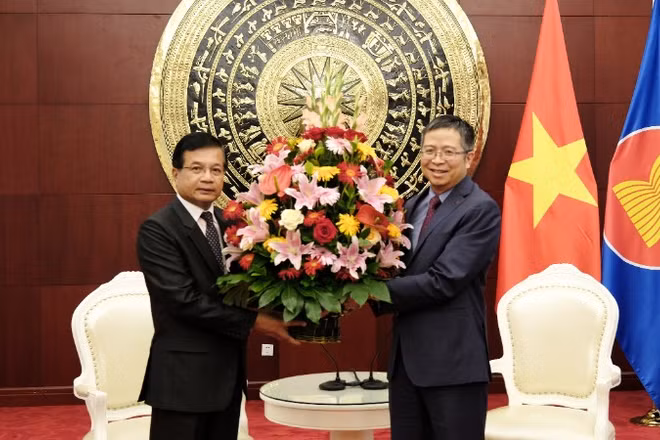 Đại sứ Lào Somphone Sichaleune tặng hoa chúc mừng Đại sứ Phạm Thanh Bình. (Ảnh: Đại sứ quán Việt Nam cung cấp)