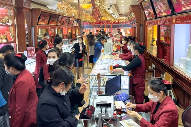 Người dân giao dịch mua vàng tại một cửa hàng trên phố Trần Nhân Tông (Hà Nội) trong bối cảnh giá vàng liên tục biến động mạnh. (Ảnh: MINH PHƯƠNG)