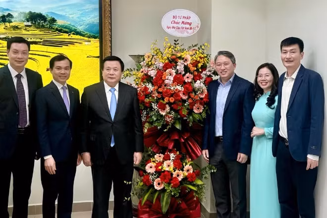 Đại diện lãnh đạo Bộ Tư pháp tặng lẵng hoa chúc mừng Học viện Chính trị quốc gia Hồ Chí Minh. 