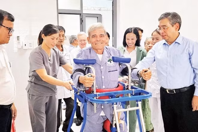 Đồng chí Nguyễn Phước Lộc (bìa phải) và người cao tuổi xã Hòa Hội đang vui vẻ bên một chiếc máy tập sức khỏe tại Điểm chăm sóc người cao tuổi của xã.