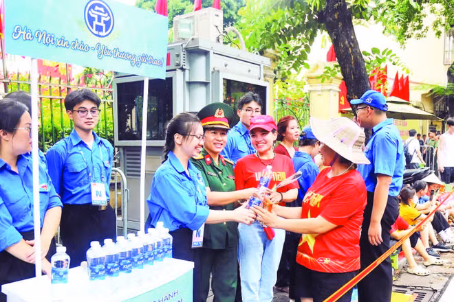 Đoàn viên thanh niên phường Hoàn Kiếm nhiệt tình giúp đỡ mọi người đến xem luyện tập diễu binh, diễu hành.