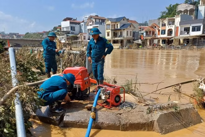 Lực lượng dân quân vận hành máy bơm, bơm nước vệ sinh đường phố, trường học tại phường Thục Phán, tỉnh Cao Bằng. (Ảnh MINH TUẤN)