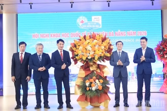 Thứ trưởng Y tế Trần Văn Thuấn tặng hoa chúc mừng Ban giám đốc Bệnh viện Đà Nẵng tổ chức thành công hội nghị. (Ảnh: ANH ĐÀO)