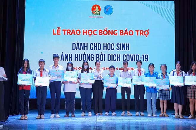 Đại diện Ban tổ chức trao học bổng bảo trợ dành cho các em học sinh bị ảnh hưởng đại dịch Covid-19. (Ảnh: CTV)