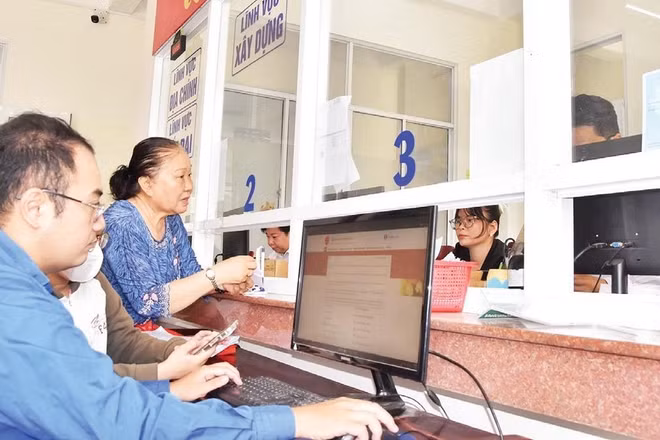 Cán bộ Trung tâm Phục vụ hành chính công phường Đạo Thạnh (tỉnh Đồng Tháp) hỗ trợ người dân xử lý hồ sơ trên môi trường số.