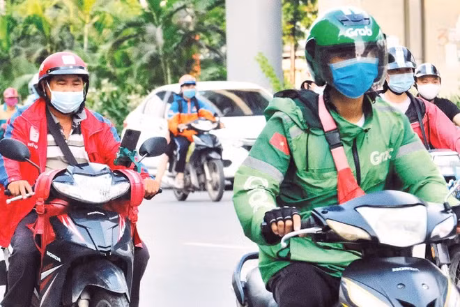 Tài xế xe công nghệ trên đường phố Hà Nội. (Ảnh: THẾ ĐẠI)