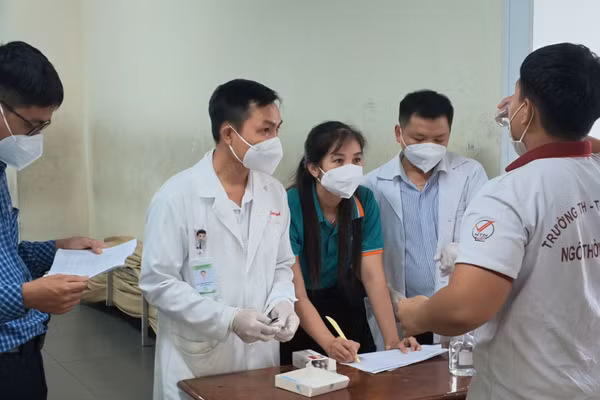 Học sinh tiếp xúc gần với ca bệnh được hướng dẫn uống kháng sinh dự phòng. (Ảnh: HCDC)