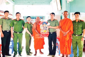 Cán bộ, chiến sĩ Công an phường Tô Châu, tỉnh An Giang, trao quà tặng đại diện chùa ở địa phương nhân dịp Tết cổ truyền Chôl Chnăm Thmây. (Ảnh: VĂN HẬU)