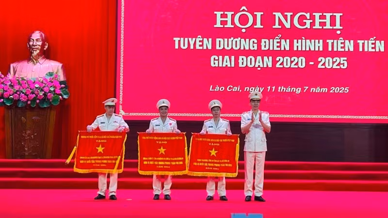Thiếu tướng Cao Minh Huyền, Giám đốc Công an tỉnh Lào Cai trao cờ thi đua của Chính phủ cho các tập thể. (Ảnh: THANH SƠN)
