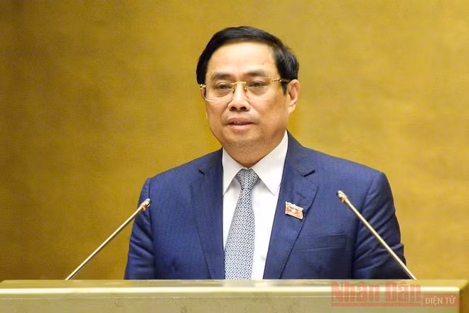 Thủ tướng Chính phủ Phạm Minh Chính trình bày trước Quốc hội Tờ trình về cơ cấu tổ chức của Chính phủ nhiệm kỳ Quốc hội khóa XV, sáng 22/7. Ảnh: DUY LINH