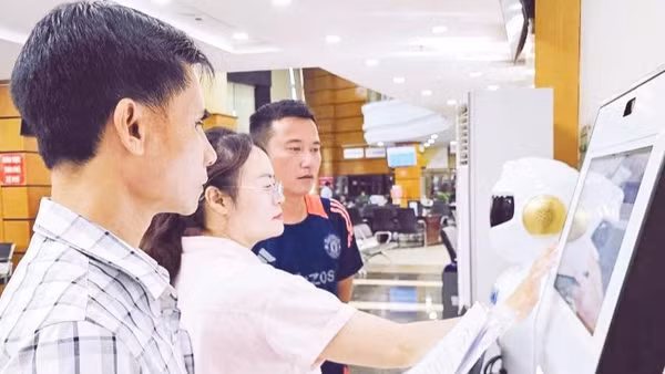 Cán bộ hướng dẫn, hỗ trợ công dân đăng nhập yêu cầu giải quyết hồ sơ hành chính qua ki-ốt thông minh.