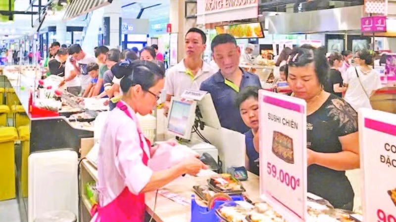 Người tiêu dùng thanh toán tại siêu thị AEON. (Ảnh ĐỖ TÂM)