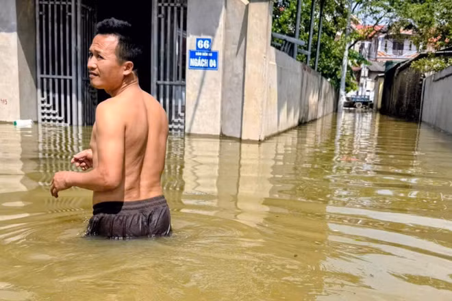 Nước lũ ngập đến ngang thân người tại khu vực Sóc Sơn. (Ảnh: VĂN THỊNH)