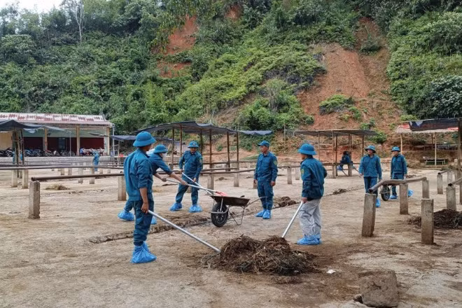 Lực lượng dân quân tự vệ xã Nghiên Loan tiến hành dọn dẹp, vệ sinh, khử trùng chợ trâu, bò. (Ảnh: Ủy ban nhân dân xã Nghiên Loan).