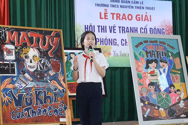 Học sinh trình bày ý nghĩa tác phẩm tại lễ trao giải Hội thi vẽ tranh cổ động về phòng, chống ma túy tại quận Cẩm Lệ (thành phố Đà Nẵng). (Ảnh ĐINH NGA) 