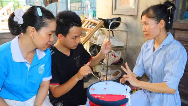 Chị Nguyễn Thị Hà (bên phải) hướng dẫn cách thêu cho người đồng cảnh ngộ.
