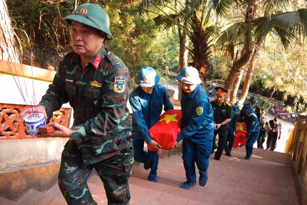 Di chuyển phần mộ các liệt sĩ tới Nhà chờ tại nghĩa trang Bản Trại. (Ảnh: DƯƠNG NGUYÊN)